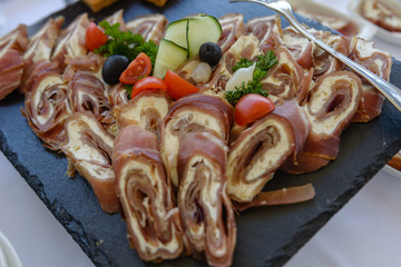 Meat rolls with green vegetables decorations