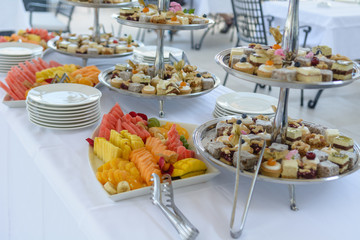 Various fuits and pastries displayed on silver tray