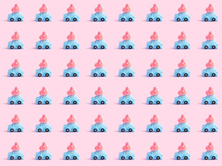 Minimal pastel pop art seamless pattern. Miniature toy blue car delivering pink thread heart. Car with heart pattern on pink background. flat lay love trevel texture