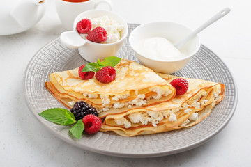 Crepes, thin pancakes with fresh raspberry,blackberry and cottage cheese.