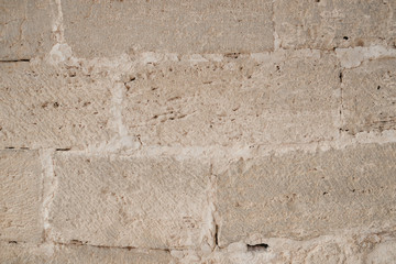 Brick wall of the ancient sandy stones in Spain