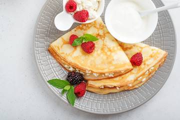 Crepes, thin pancakes with fresh raspberry,blackberry and cottage cheese. top view