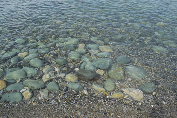 Underwater stones and pebbles. Clear and quiet sea water.