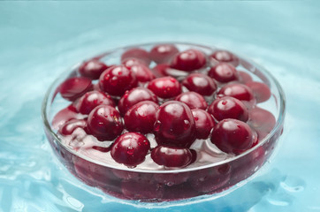 Washed ripe cherries in a bowl of water
