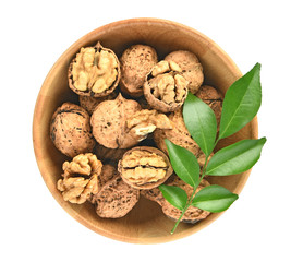 Top view of Walnuts kernels in wooden bowl on white background