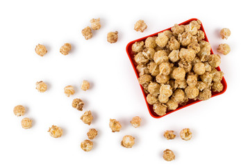 Caramel popcorn in a quadratic red plate, isolated on white background