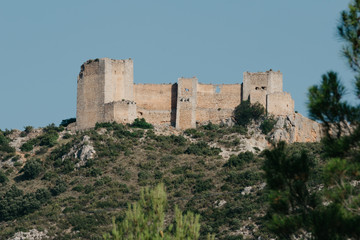 Fototapeta na wymiar An ancient castle on the pick of the hill in Spain in the evening. El Castillo de Chirel. 