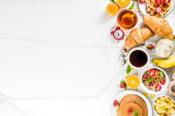 Healthy breakfast eating concept, various morning food - pancakes, waffles, croissant oatmeal sandwich and granola with yogurt, fruit, berries, coffee, tea, orange juice, white background - obrazy, fototapety, plakaty