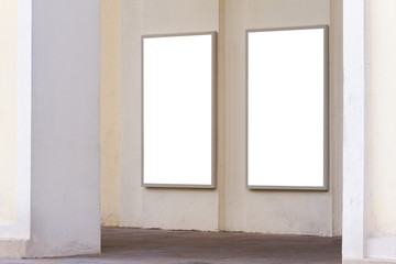 Two blank advertising billboards on the wall.