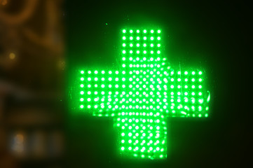 Luminous made with fluorescent green bright neon lights. Pharmacy sign