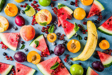 Summer vitamin food concept, various fruit and berries watermelon peach mint plum apricots...