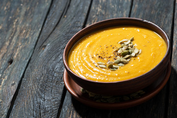 pumpkin soup on wooden background
