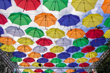 Fototapeta na wymiar colored umbrellas on the sky background