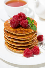stack of pancakes with fresh raspberries for breakfast, vertical top view
