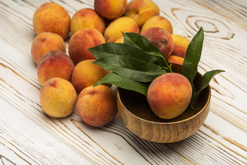 Naklejka na ściany i meble plate with fresh and ripe peaches on a table