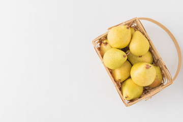 Yellow pears in a wooden basket