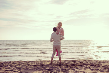 Loving young couple on a beach at autumn sunny day