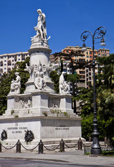 Fototapeta na wymiar Genoa, Italy - monument to Christopher Columbus in Piazza Acquaverde, built in 1862. At the four corners of the pedestal 4 statues symbolizing nautics, religion, cautiousness and strength