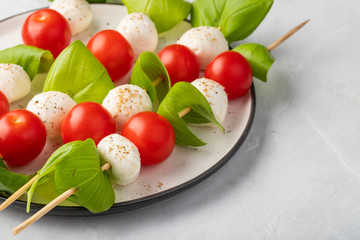 Caprese salad - skewer with tomato, mozzarella and basil, italian food and healthy vegetarian diet...