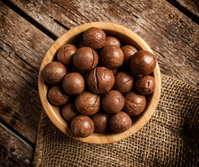 Macadamia nuts on wooden table.
