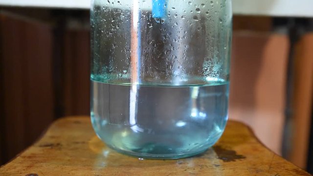 Samogon falling into a glass three-liter jar. Preparation a moonshine at home, distillation process