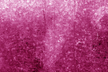 Old metal surface with scratches in pink tone.