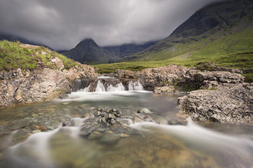 Fototapeta na wymiar Waterfall in the Fairy Pools rocky stream on Isle of Skye