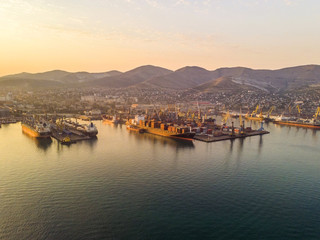 Fototapeta premium Container ship in import export and business logistics, By crane, Trade Port, Shipping cargo to harbor, Aerial view from drone, International transportation, Business logistics concept