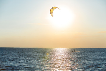 professional kiter doing a complicated trick on a beautiful sunset background
