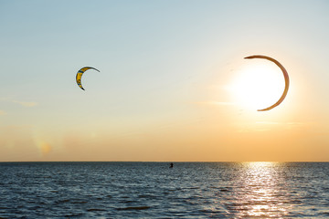 professional kiter doing a complicated trick on a beautiful sunset background