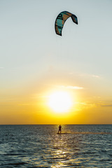 professional kiter doing a complicated trick on a beautiful sunset background