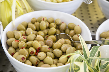 Green Olives Stuffed With Paprika on a plate.