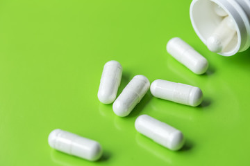  Pills on green background. Healthy concept