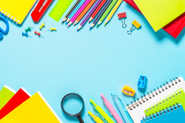 School and office supplies on blue background.
