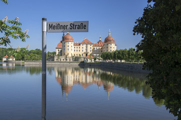 Castle Moritzburg in Saxony near Dresden in Germany surrounded by pond, reflection blue lake, blue...