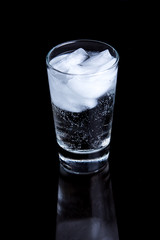 Bubbly drink in a glass on a black background