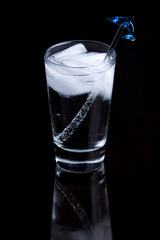 Bubbly drink in a glass on a black background