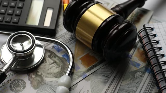 Health expence and justice concept, calculator, money and stethoscope
