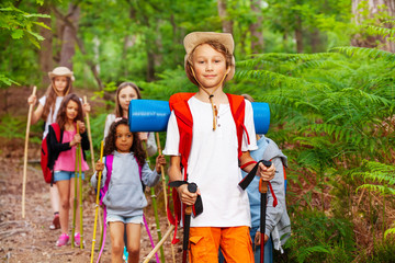 Boy portrait in group of friends hiking