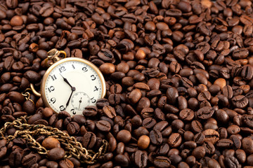 old hand watch on coffee beans