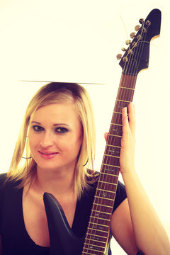 Woman with electrical guitar and vinyl record.