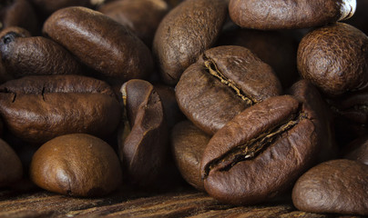 Coffee seeds on grunge wooden background