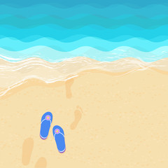 Flip flops and footsteps on the sand