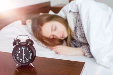 Woman sleeping with alarm clock