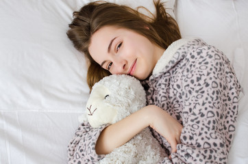 Teen girl sleeping with toy