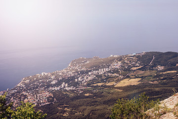 View of the sea coast of the city from a bird's flight in the mountains.