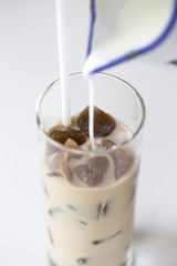 Iced coffee cocktail or frappe with ice cubes and cream