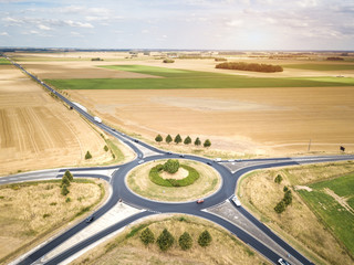 Roundabout drone aerial view with vehicles circling around the traffic circle lane, France country...