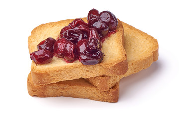 Gooseberry jam with fresh berries on crispy toasters, isolated on white background.