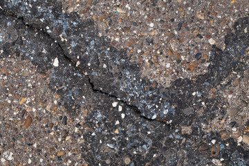 Close-up texture of a cracked asphalt